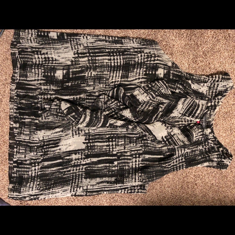Black and white sleeveless front ruffle shirt